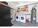 Convenient indoor laundry room with washer, dryer, and extra storage at 8224 Country Oaks Ct, Sarasota, FL 34243