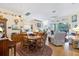 Bright dining room with wood table and chairs, hardwood floors, and access to living area at 8412 Whispering Woods Ct, Lakewood Ranch, FL 34202