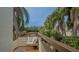 Relaxing balcony with seating area and lush tropical views at 119 Tidewater Dr # 119, Bradenton, FL 34210