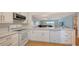 Open concept kitchen with white cabinets and island seating at 119 Tidewater Dr # 119, Bradenton, FL 34210