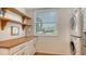 Laundry room with stacked LG washer and dryer, and wood counter at 119 Tidewater Dr # 119, Bradenton, FL 34210