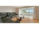 Spacious living room with leather sectional sofa and glass coffee table at 119 Tidewater Dr # 119, Bradenton, FL 34210