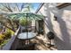 Private patio with table, chairs, and umbrella, ideal for outdoor dining and relaxation at 1611 Clower Creek Dr # Ha236, Sarasota, FL 34231