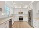 Modern kitchen with stainless steel appliances and white cabinets at 280 Hidden Bay Dr # 201, Osprey, FL 34229