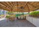 Tiki bar with grill and seating area at 280 Hidden Bay Dr # 201, Osprey, FL 34229