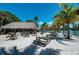 Beachfront picnic area with tables and thatch roof at 3029 Homasassa Rd, Sarasota, FL 34239