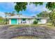 Charming single story home with teal accents and a spacious driveway at 3029 Homasassa Rd, Sarasota, FL 34239