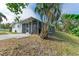 Ranch style home with teal accents and a covered patio at 3029 Homasassa Rd, Sarasota, FL 34239