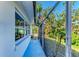 Screened-in side patio with concrete flooring at 3029 Homasassa Rd, Sarasota, FL 34239