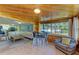 Sunroom with wood ceiling, table and seating area at 3029 Homasassa Rd, Sarasota, FL 34239