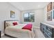 Bright bedroom featuring a comfortable bed and dark dresser at 4939 Surfside Cir, Bradenton, FL 34211