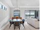 Elegant dining room with a large window and modern light fixture at 4939 Surfside Cir, Bradenton, FL 34211