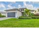 One-story home with gray garage door and lush landscaping at 4939 Surfside Cir, Bradenton, FL 34211