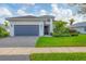 Single-story home with gray garage door and well-manicured lawn at 4939 Surfside Cir, Bradenton, FL 34211