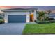 Modern house exterior with gray garage door and landscaping at 4939 Surfside Cir, Bradenton, FL 34211