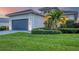 Modern house exterior with gray garage door and green lawn at 4939 Surfside Cir, Bradenton, FL 34211