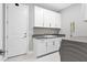 Laundry room with white cabinets and granite countertop at 4939 Surfside Cir, Bradenton, FL 34211