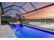 Luxury pool and patio with water feature and sunset view at 4939 Surfside Cir, Bradenton, FL 34211
