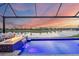 Luxury pool and patio with water feature and sunset view at 4939 Surfside Cir, Bradenton, FL 34211