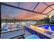 Relaxing pool and patio area with fire pit and sunset view at 4939 Surfside Cir, Bradenton, FL 34211