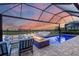 Relaxing pool and patio area with fire pit at sunset at 4939 Surfside Cir, Bradenton, FL 34211