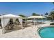 Enjoy the shade in this pool area with multiple white cabanas at 4939 Surfside Cir, Bradenton, FL 34211
