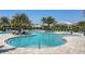 Large freeform pool surrounded by cabanas and lounge chairs at 4939 Surfside Cir, Bradenton, FL 34211