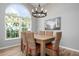 Elegant dining room featuring a wood table, wicker chairs, and an arched window at 502 Woodstork Cir, Bradenton, FL 34209