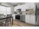 Modern kitchen with stainless steel appliances and white shaker cabinets at 502 Woodstork Cir, Bradenton, FL 34209