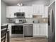Modern kitchen with stainless steel appliances and white shaker cabinets at 502 Woodstork Cir, Bradenton, FL 34209