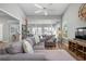 Relaxing living room featuring a gray sectional and access to a sunroom and other rooms at 502 Woodstork Cir, Bradenton, FL 34209