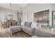 Open living area with gray sectional sofa and adjacent dining area with wood table and chairs at 502 Woodstork Cir, Bradenton, FL 34209
