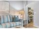 Living room with striped sofa, white coffee table, and access to a screened porch at 502 Woodstork Cir, Bradenton, FL 34209