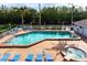 Community pool and spa with lounge chairs for relaxation at 502 Woodstork Cir, Bradenton, FL 34209