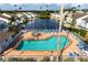 Community pool with spa and lounge chairs, offering a relaxing waterfront view at 502 Woodstork Cir, Bradenton, FL 34209