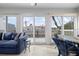 Relaxing sunroom with blue sofa and wicker chairs, offering stunning water views at 502 Woodstork Cir, Bradenton, FL 34209