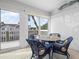 Sunroom with a glass-top table and wicker chairs, offering water views from the deck at 502 Woodstork Cir, Bradenton, FL 34209