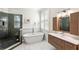 Luxurious bathroom featuring a freestanding tub, glass-enclosed shower, and modern vanity at 5159 Oxford Dr, Sarasota, FL 34242