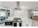 Stylish kitchen island with stainless steel appliances and a view of the outdoor patio at 5159 Oxford Dr, Sarasota, FL 34242