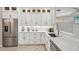 Modern white kitchen with stainless steel appliances and ample counter space at 5159 Oxford Dr, Sarasota, FL 34242