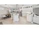 Bright kitchen featuring white cabinets, stainless steel appliances, and an open layout at 5159 Oxford Dr, Sarasota, FL 34242