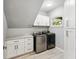 Functional laundry room with modern appliances, ample storage, and white cabinetry at 5159 Oxford Dr, Sarasota, FL 34242