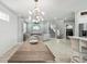 Spacious living room with modern decor, a large chandelier, and access to the staircase at 5159 Oxford Dr, Sarasota, FL 34242