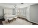 Bright main bedroom showcasing a large bed, bay windows with shutters, and hardwood floors at 5159 Oxford Dr, Sarasota, FL 34242