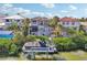 Stunning waterfront home featuring a private boat dock, lush tropical landscaping, and backyard tiki bar at 5159 Oxford Dr, Sarasota, FL 34242