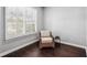 Cozy sitting area with a comfortable chair and ample natural light from the large window at 5159 Oxford Dr, Sarasota, FL 34242