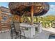 Outdoor tiki bar featuring a marble countertop, stainless steel grill, and bar seating at 5159 Oxford Dr, Sarasota, FL 34242