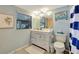 Simple bathroom with white vanity, blue walls, and striped shower curtain at 521 Cummings St, Sarasota, FL 34242