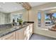 Elegant bathroom with granite countertops, dual sinks, and a large window at 521 Cummings St, Sarasota, FL 34242