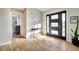 Bright entryway with wood-look floors, modern door, and a console table at 521 Cummings St, Sarasota, FL 34242